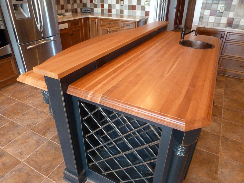1.5" and 1.75" thick American Cherry edge grain countertops with 1/4" roundover and large format Roman ogee edge treatments and permanent finish