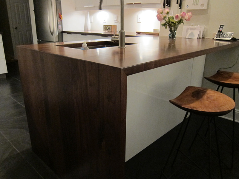 1.5" thick Walnut flat grian countertops with 1/8" roundover edge treatment and permanent finish over Dark Walnut stain