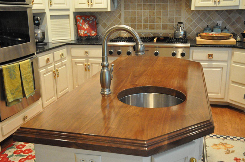 2.25" thick Walnut flat grain countertop with custom edge treatment and permanent finish over Early American stain