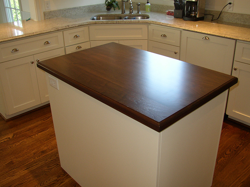 1.5" thick Walnut flat grain countertop with ogee edge treament and permanent finish over dark walnut stain