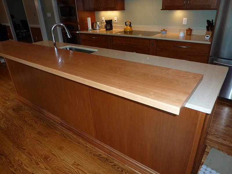 1.5" thick American Cherry flat grain countertop with 1/8" roundover edge treatment and permanent finish